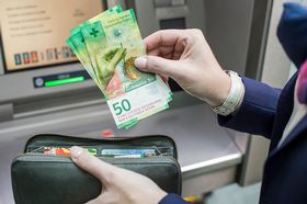 50-franc notes being withdrawn from an ATM