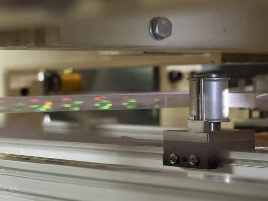 Feeding in the security strip prior to application